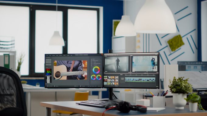 Computer on desk with video editing software